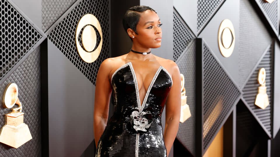 Janelle Monáe wore a silver and black sequined Armani Privè dress with rosette detailing at the waist. She completed the look with a black choker, featuring a diamond centerpiece, by Yeprem Jewellery. - Frazer Harrison/Getty Images