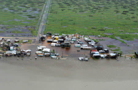 Housing surrounded by flood waters caused by Hurricane Harvey is seen from a U.S. Coast Guard helicopter during an overflight from Port Aransas to Port O'Connor, Texas, August 26, 2017. U.S. Coast Guard/Petty Officer 3rd Class Johanna Strickland/Handout via REUTERS