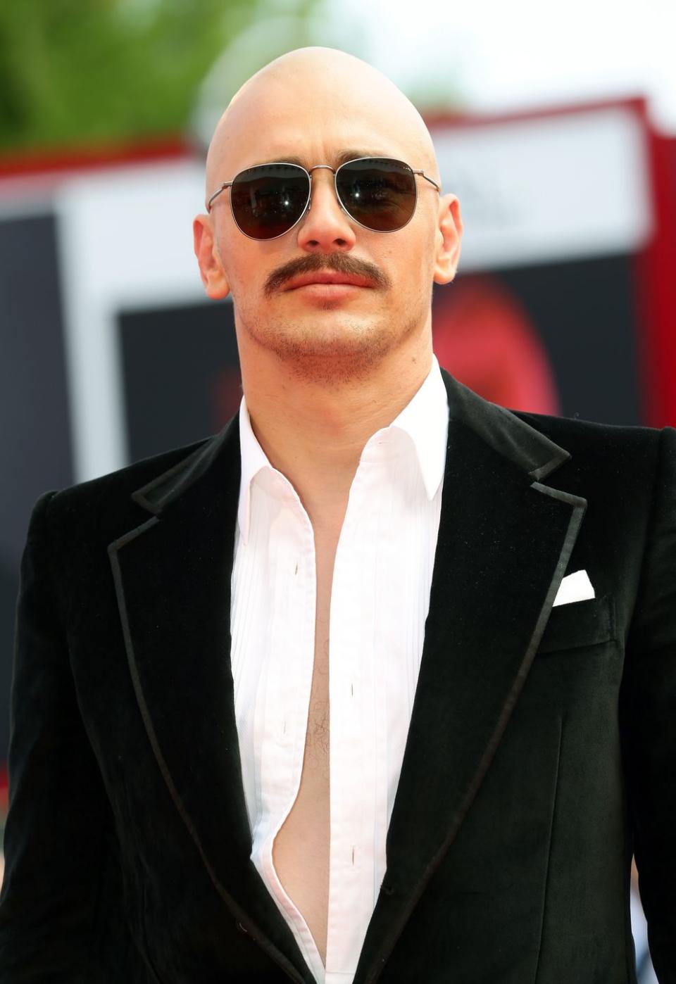 <p>James Franco is hardly recognizable with a clean-shaven head, mustache and sunglasses at the Venice Film Festival. While the actor was in character at the red carpet event in order to<a href="https://variety.com/2014/film/festivals/james-franco-shoots-zeroville-at-venice-film-fest-1201298666/" rel="nofollow noopener" target="_blank" data-ylk="slk:film a scene;elm:context_link;itc:0;sec:content-canvas" class="link "> film a scene</a>, his bald head was 100% real. </p>