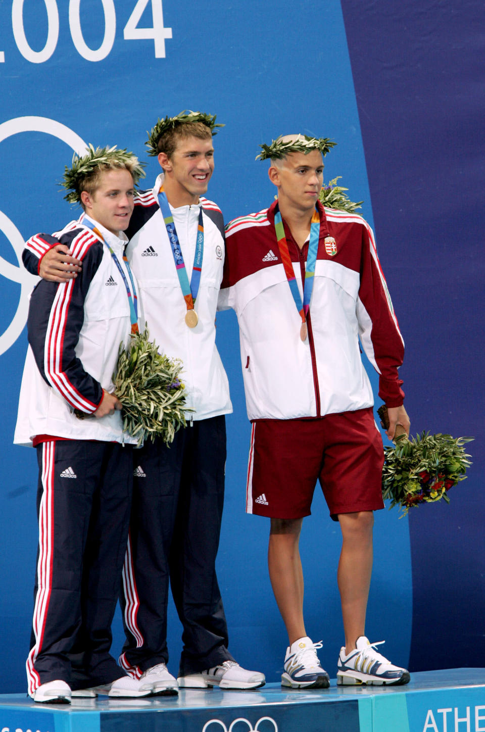 <b>Medal No. 1: </b>Michael Phelps wins the Olympic gold and sets a new world record in men's 400-meter Individual Medley in 4:08:26 ahead of compatriot Erik Vendt (left) and Hungary's Laszlo Cseh at the Olympic Aquatic Centre in Athens, Greece, August 14, 2004. It was the first of many Olympic medals for Phelps.