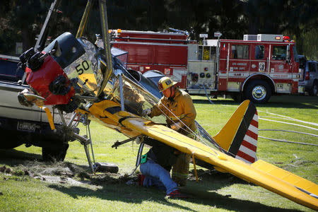FILE PHOTO: Actor Harrison Ford's damaged airplane is taken away after its crash landing at Penmar Golf Course in Venice, Los Angeles California March 6, 2015. REUTERS/Lucy Nicholso/File PHoto