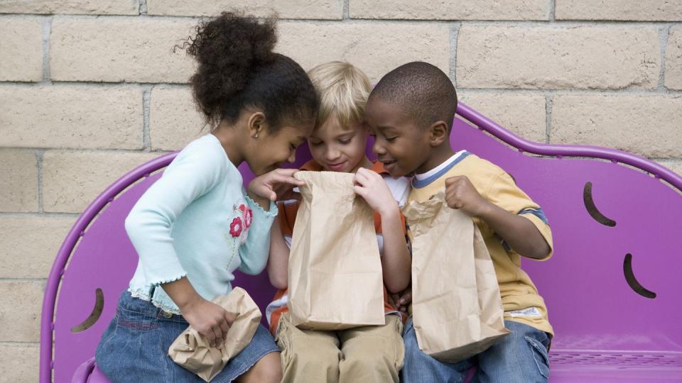 back to school activities, kids looking inside a brown paper bag