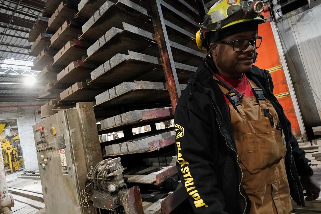 A stack of concrete blocks created with liquid carbon dioxide as an ingredient is pulled from a curing kiln at the Glenwood Mason Supply Company, Tuesday, April 18, 2023, in the Brooklyn borough of New York. New York is forcing buildings to clean up, and several are experimenting with capturing carbon dioxide, cooling it into a liquid and mixing it into concrete where it turns into a mineral. (AP Photo/John Minchillo)