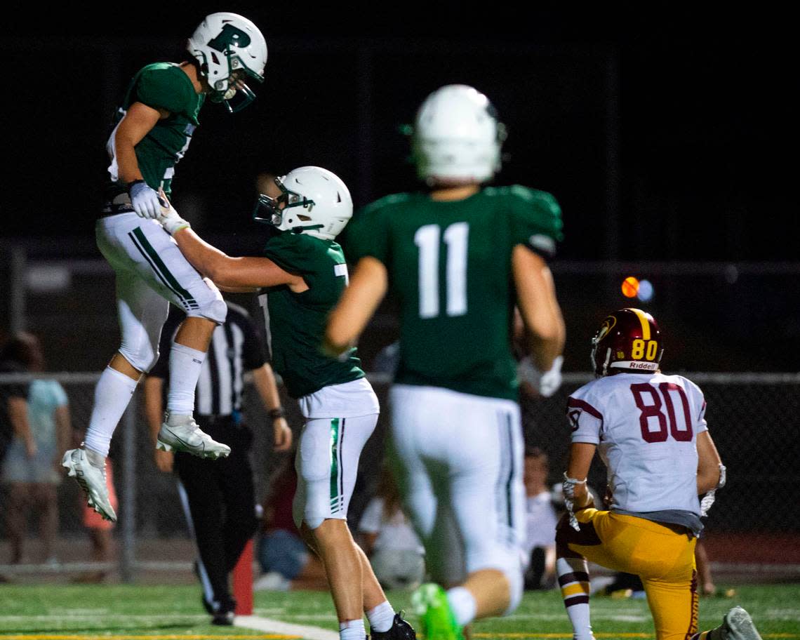 Peninsula receiver Dane Meddaugh is lifted up after catching a touchdown pass from quarterback Payton Knowles during the fourth quarter of a nonleague game against Enumclaw on Thursday, Sept. 1, 2022, at Roy Anderson Field in Gig Harbor Wash.