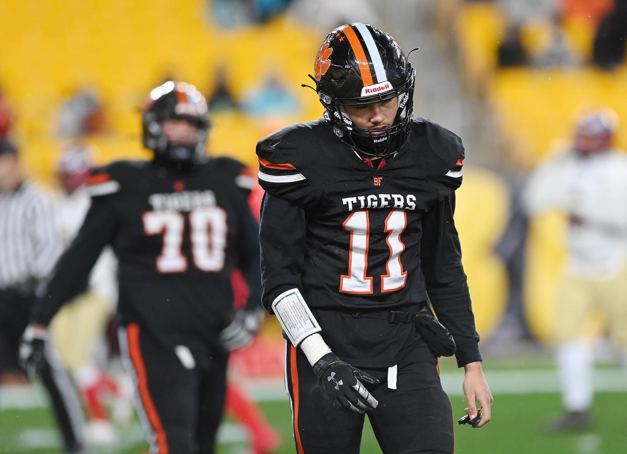 Beaver Falls' quarterback Jaren Brickner walks off the field after throwing an interception during the WPIAL Class 2A championship game against Serra Catholic, Friday at Heinz Field.