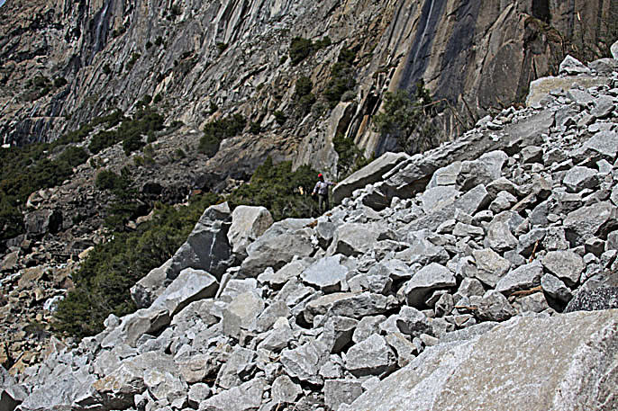 In this photo supplied by Yosemite National Park, a rockfall is seen on Monday, March 31, 2014. Officials at Yosemite National Park say a massive amount of rock has fallen from a cliff, closing a hiking trail. The National Park Service said nobody was hurt on March 31 when approximately 16,000 tons of rock fell 500 feet from a cliff near Hetch Hetchy Reservoir. Officials say the rock crashed down from a cliff east of Wapama Falls. Some 400 feet of the Rancheria Falls Trail were destroyed and park staff says it will remain closed for now. Park officials say hikers can still get to Wampama Falls starting at O'Shaughnessy Dam. (AP Photo/Yosemite National Park)