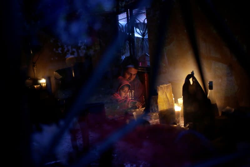 Jesus Mendoza 35 and his daughter Victoria Mendoza eat a meal at their farm in Jalpan de Serra