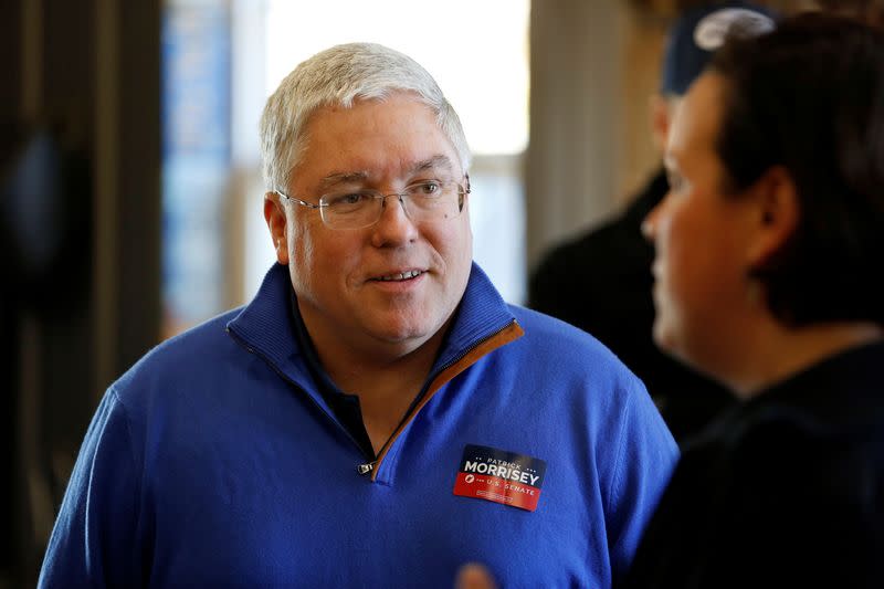 Republican senate nominee Patrick Morrisey greets supporters at a blacksmith's forge ahead of the 2018 midterm elections in Falling Water, West Virginia