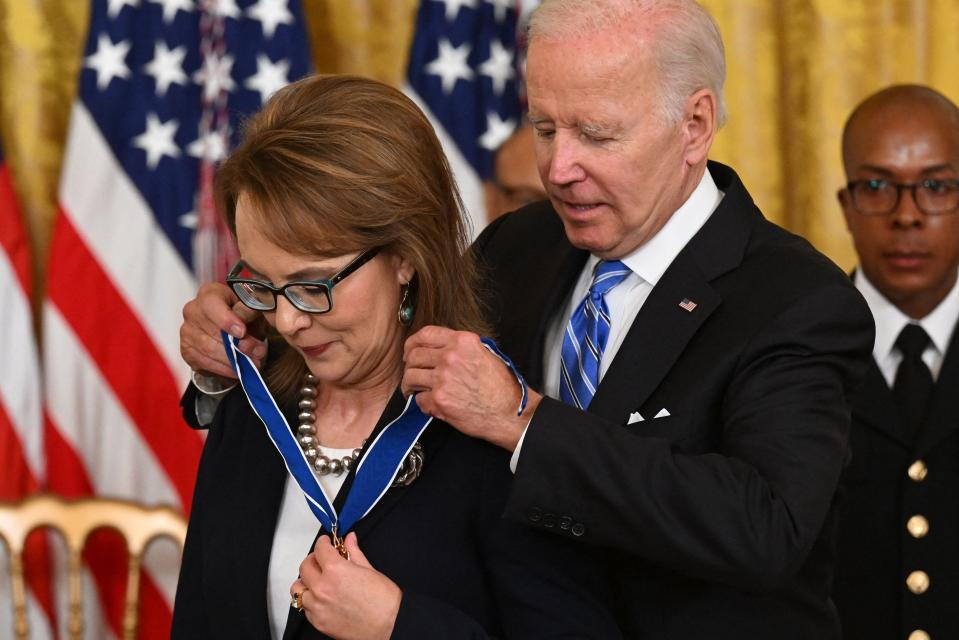 US President Joe Biden presents former Congresswoman Gabby Giffords with the Presidential Medal of Freedom, the nation's highest civilian honor, during a ceremony honoring 17 recipients, in the East Room of the White House in Washington, DC, July 7, 2022. (Photo by SAUL LOEB / AFP) (Photo by SAUL LOEB/AFP via Getty Images)