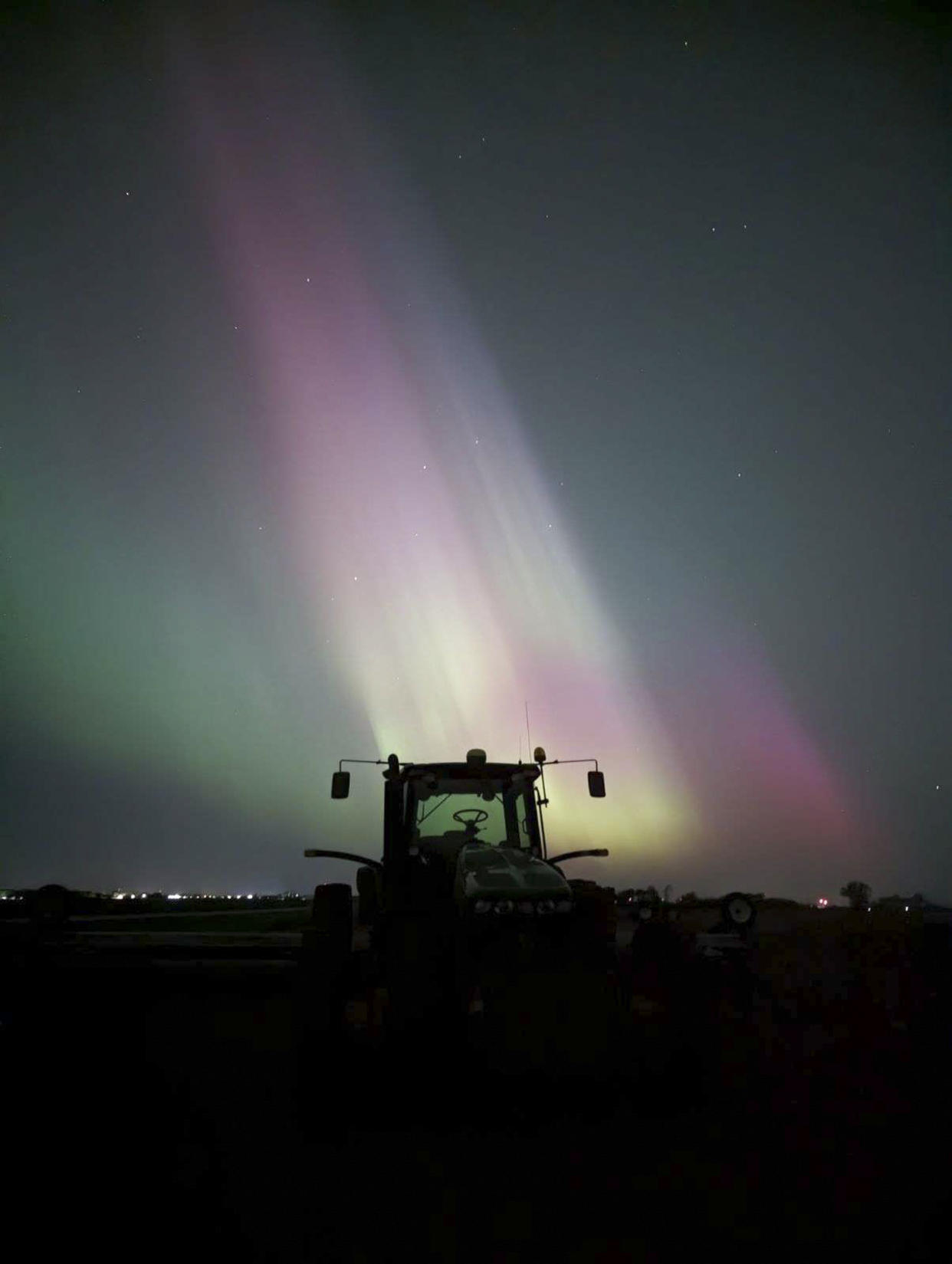 In an undated photo from Tiffany Graham, an aurora over a tractor at O