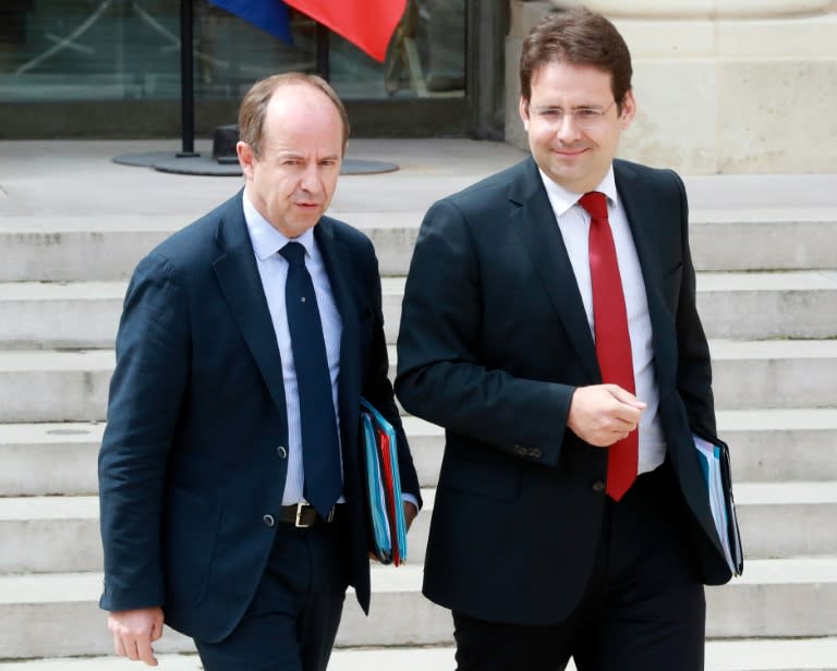 French Justice minister Jean-Jacques Urvoas (L) speaks with French Junior minister for External Trade Matthias Fekl as they leave after the cabinet meeting on August 3, 2016 at the Elysee Presidential Palace in Paris