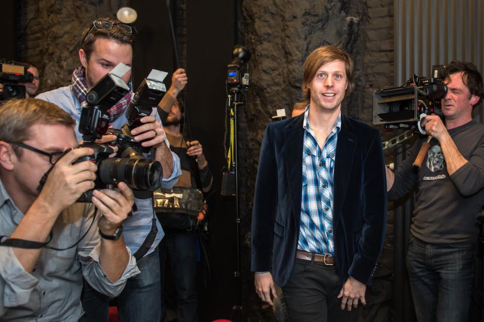 In this Thursday, Jan. 16, 2014 file photo, Belgian director Felix Van Groeningen, center, nominee for the Oscar 2014 foreign language film 'The Broken Circle Breakdown' smiles as he arrives for a media conference in Brussels. The small European country of Belgium, birthplace of Audrey Hepburn and Jean-Claude Van Damme, has never won a foreign film Oscar. This year, it has a nominee in “Broken Circle Breakdown,” a heartstring-tugging drama with a bluegrass soundtrack about a man and woman who fall in love and must confront tragedy when their daughter develops cancer. (AP Photo/Geert Vanden Wijngaert, File)