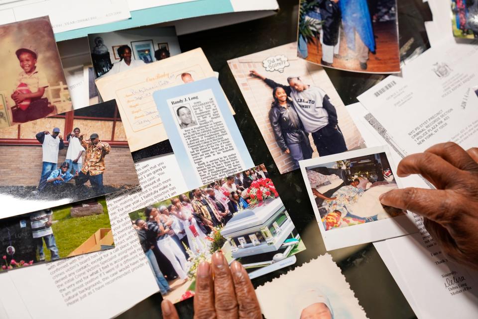 Debra Long looks through documents about the murder of her son, Randy Long, and photographs from his life, at her home in Poughkeepsie, N.Y., April 19, 2023. An AP examination of data from 23 states shows that Black people are disproportionately denied aid from programs that reimburse victims of violent crime. (AP Photo/Seth Wenig)