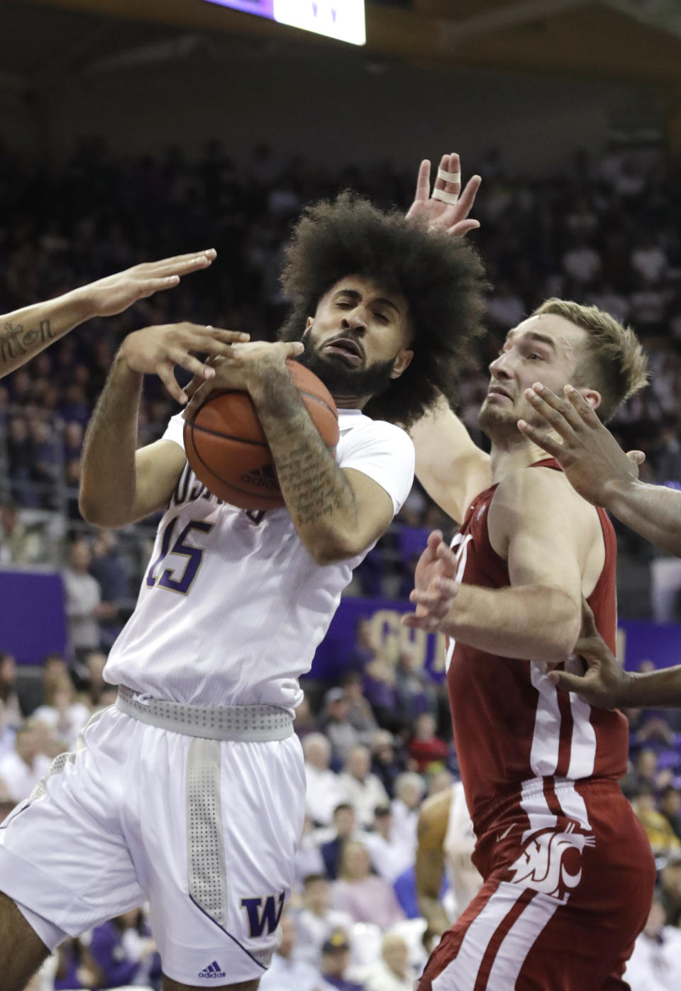 Washington's Marcus Tsohonis (15) tries to hold on to the ball in front of Washington State's Jeff Pollard during the first half of an NCAA college basketball game Friday, Feb. 28, 2020, in Seattle. (AP Photo/Elaine Thompson)