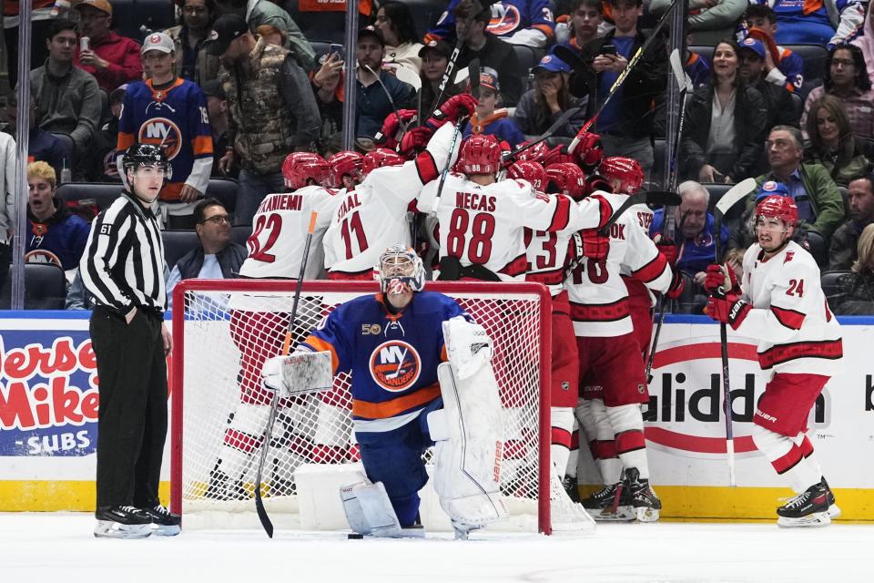 New York Islanders goaltender Ilya Sorokin looks up as the Carolina Hurricanes celebrate a goal by Paul Stastny during overtime in Game 6 of an NHL hockey Stanley Cup first-round playoff series Friday, April 28, 2023, in Elmont, N.Y. The Hurricanes won 2-1. (AP Photo/Frank Franklin II)