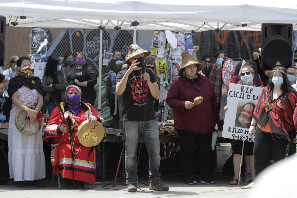 Members of Native American tribal groups speak Sunday, June 14, 2020, inside what has been named the Capitol Hill Occupied Protest zone in Seattle. Protesters calling for police reform and other demands have taken over several blocks near downtown Seattle after officers withdrew from a police station in the area following violent confrontations. (AP Photo/Ted S. Warren)