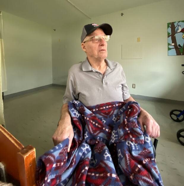 Cyril Mooney, 83, would often have the colourful blanket on his lap when he read, or when he was chilly. (Janice Mooney - image credit)