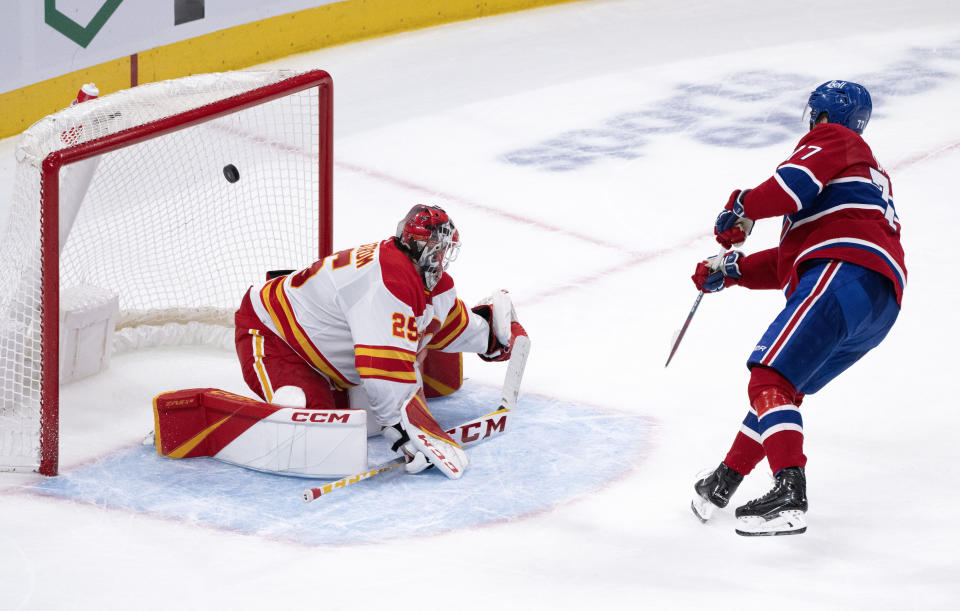 Montreal Canadiens' Kirby Dach scores past Calgary Flames goaltender Jacob Markstrom during the shootout of an NHL hockey game in Montreal, Monday, Dec. 12, 2022. (Paul Chiasson/The Canadian Press via AP)