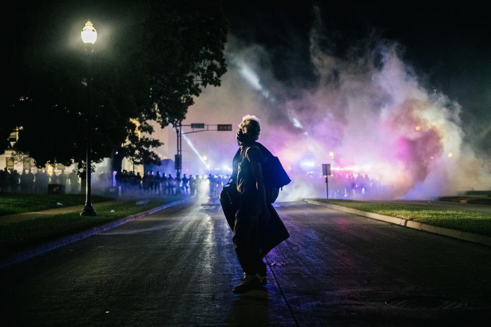 A demonstrator stands in the street with a make-shift shield on Aug. 25, 2020, in Kenosha, Wis. As the city declared a state of emergency curfew, a third night of civil unrest occurred after the shooting of Jacob Blake, 29, on August 23.