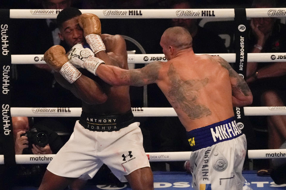 Oleksandr Usyk of Ukraine hits Anthony Joshua of Britain during their WBA (Super), WBO and IBF boxing title bout at the Tottenham Hotspur Stadium in London, Saturday, Sept. 25, 2021. (AP Photo/Frank Augstein)