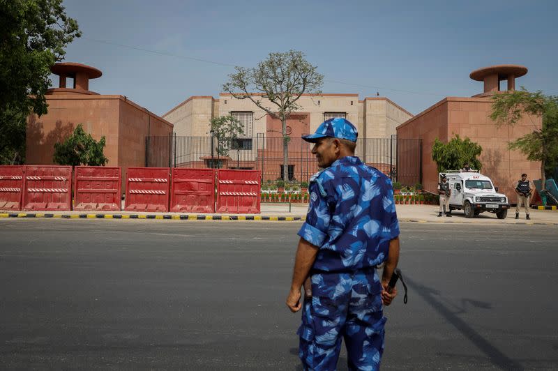 A policeman stands guard outside the India's new parliament building before its inauguration in New Delhi