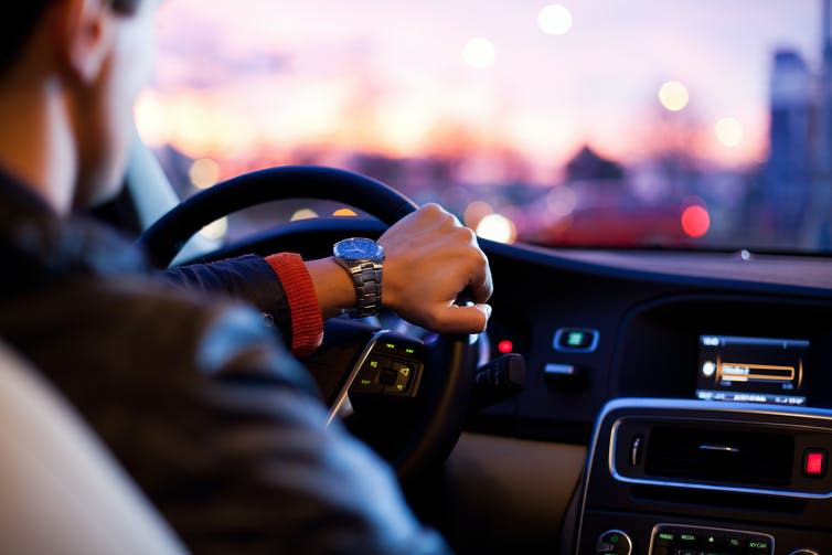 Man at wheel of car