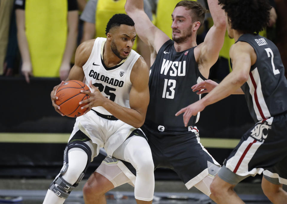 Colorado forward Dallas Walton, left, drives to the rim as Washington State forwards Jeff Pollard, center, and CJ Elleby defend in the first half of an NCAA college basketball game Thursday, Jan. 23, 2020, in Boulder, Colo. (AP Photo/David Zalubowski)