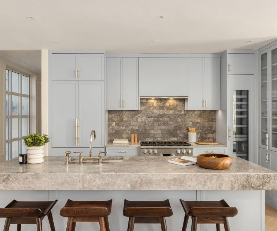 Baby blue cabinets, wooden chairs