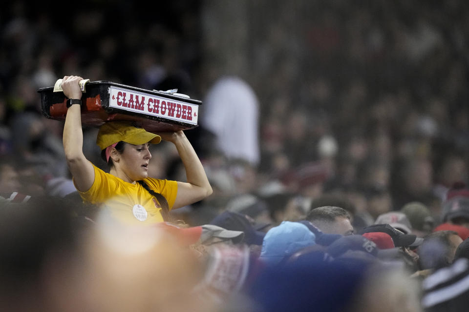 A vendor works the crowd during the first inning in Game 3 of baseball's American League Championship Series between the Houston Astros and the Boston Red Sox Monday, Oct. 18, 2021, in Boston. (AP Photo/David J. Phillip)