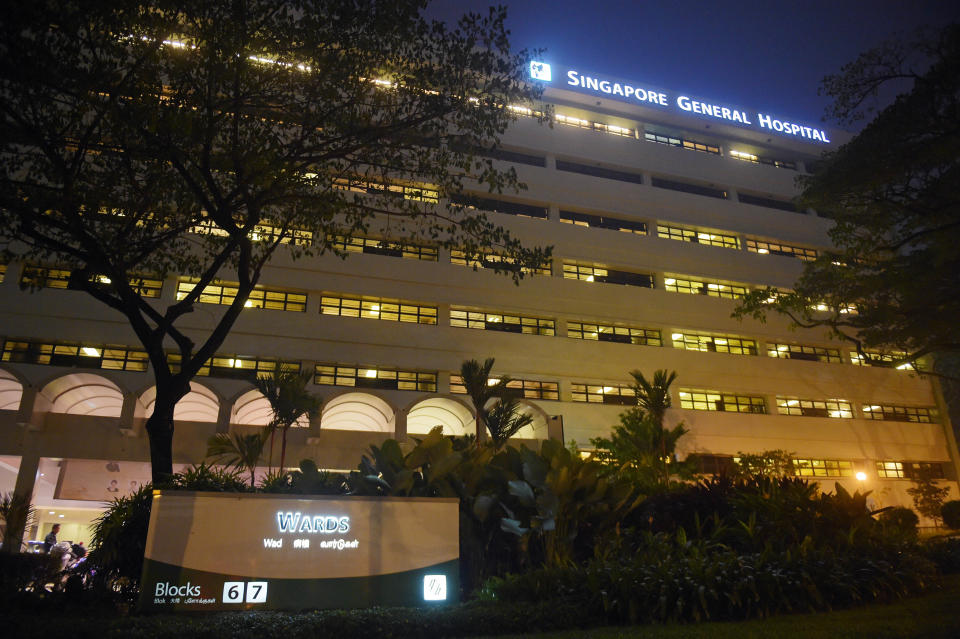 The windows of wards are seen with the sign of  Singapore General Hospital on Tuesday, Oct. 6, 2015 in Singapore.  The top public hospital in Singapore said Tuesday that four of its patients died after a new renal ward was hit by an outbreak of hepatitis C, likely from intravenous treatment. (AP Photo/Joseph Nair)