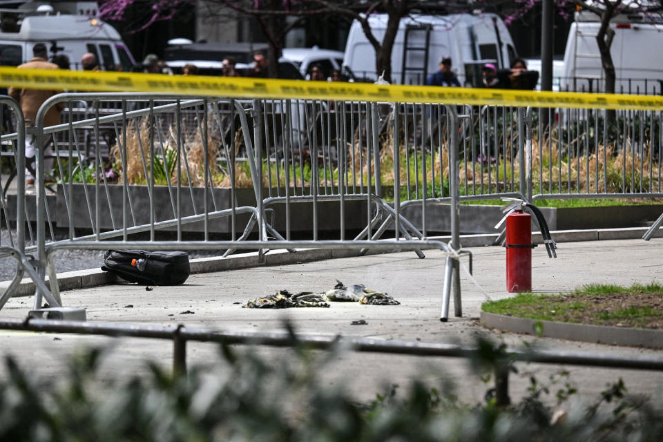 Image: Fire extinguishers are left in the park across from the Manhattan Criminal Court in New York City after a man set himself on fire (Angela Weiss / AFP - Getty Images)