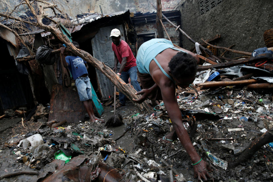 People sort through the wreckage of their destroyed house on Oct. 16, 2016.