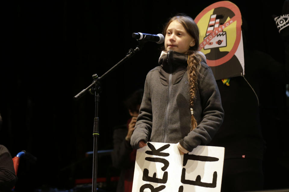 Climate activist Greta Thunberg speaks to assistants during a demonstration in Madrid, Friday Dec. 6, 2019. Thunberg arrived in Madrid Friday to join thousands of other young people in a march to demand world leaders take real action against climate change. (AP Photo/Andrea Comas)