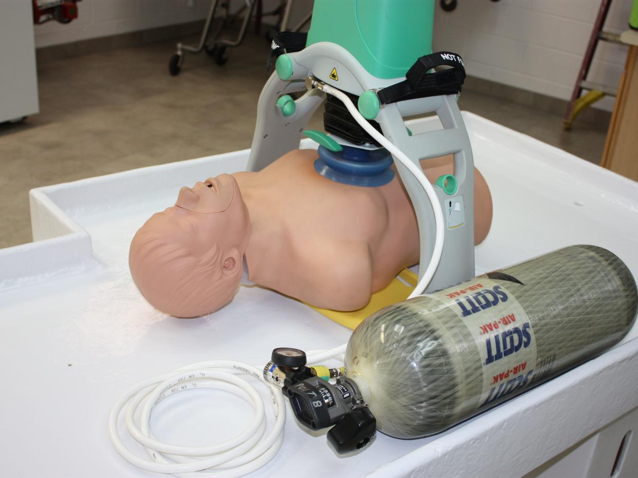 Automatic CPR machine is attached to a body while on standby.