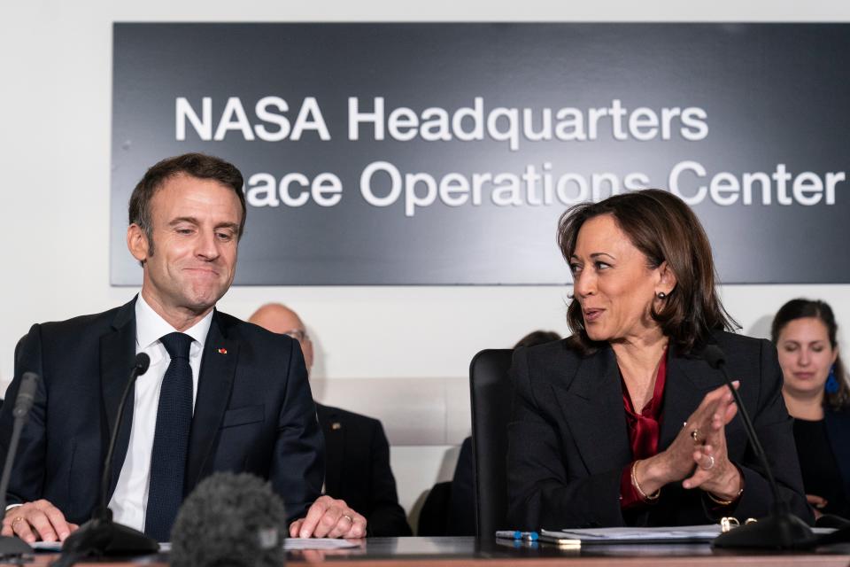 French president Emmanuel Macron, left, and Vice President Kamala Harris speak during a meeting to highlight space cooperation between the two countries, at Nasa headquarters in Washington, Wednesday, 30 November 2022 (AP)