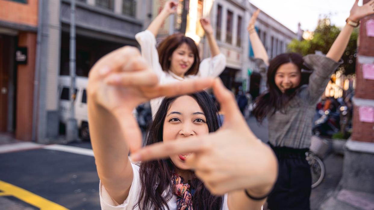 millennial friends jumping for photo