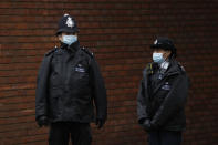 Police officers stand outside the King Edward VII Hospital in London, Friday, Feb. 19, 2021. Buckingham Palace said the husband of Queen Elizabeth II, 99-year-old Prince Philip was admitted to the private King Edward VII Hospital on Tuesday evening after feeling unwell. (AP Photo/Matt Dunham)