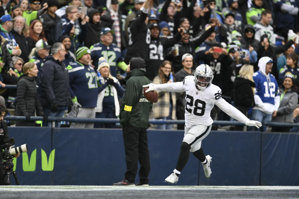 Las Vegas Raiders running back Josh Jacobs (28) celebrates after scoring a touchdown during the first half of an NFL football game against the Seattle Seahawks Sunday, Nov. 27, 2022, in Seattle. (AP Photo/Caean Couto)