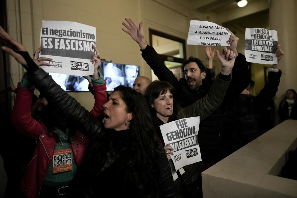 Demonstrators protest inside the Buenos Aires City Legislature against an event organized by Victoria Villarruel, the running mate of Freedom Advances party presidential candidate Javier Milei, to honor the 1970's victims of armed leftist groups. (AP Photo/Rodrigo Abd)