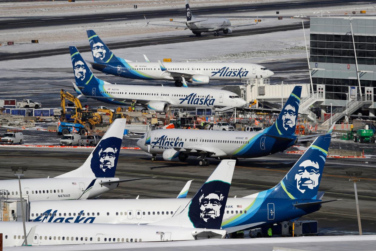 In this Feb. 5, 2019, file photo, Alaska Airlines planes are parked at a gate area at Seattle-Tacoma International Airport in Seattle.  (AP Photo/Ted S. Warren, File)