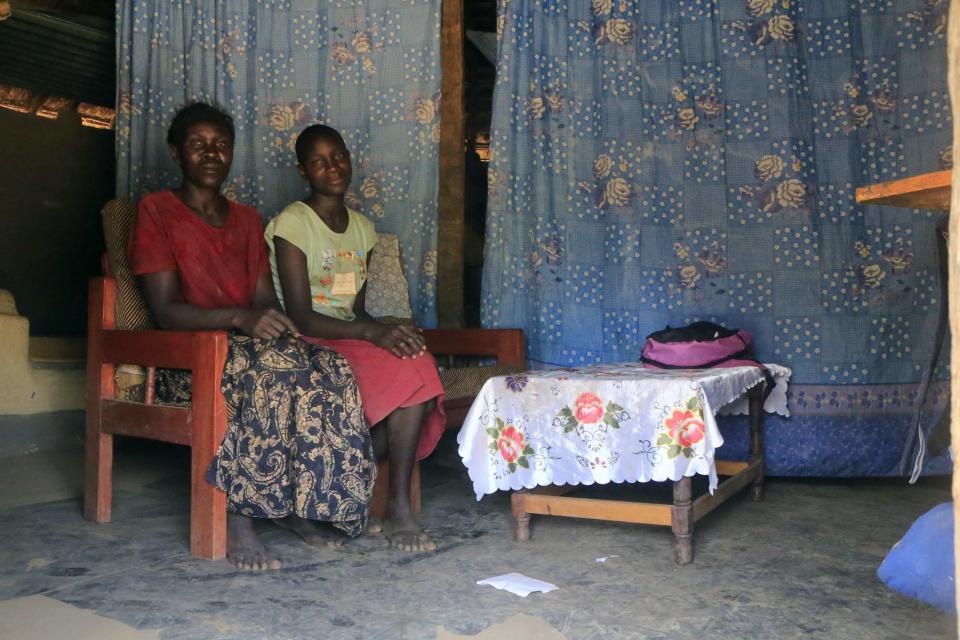 Lucy Oyela poses for a photograph with her daughter Abber Lillian at their home in Onang near Gulu town in northern Uganda