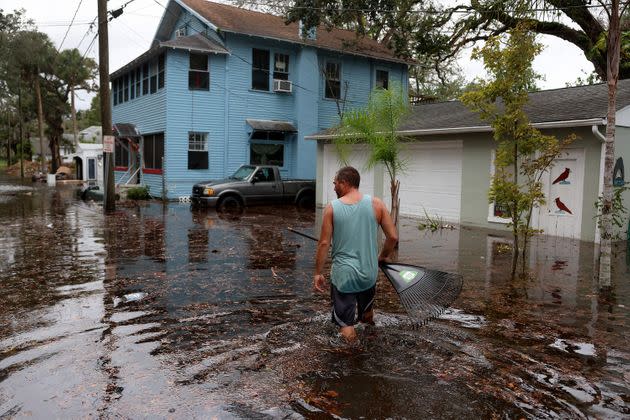 A man walks through flood water that surrounds his home in Daytona Beach on Thursday. (Photo: Joe Raedle via Getty Images)