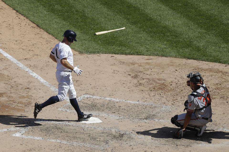 New York Yankees' Brett Gardner, left, reaches home plate on a sacrifice fly ball by Didi Gregorius during the seventh inning as Baltimore Orioles catcher Pedro Severino, right, watches in the first game of a baseball doubleheader Monday, Aug. 12, 2019, in New York. (AP Photo/Frank Franklin II)