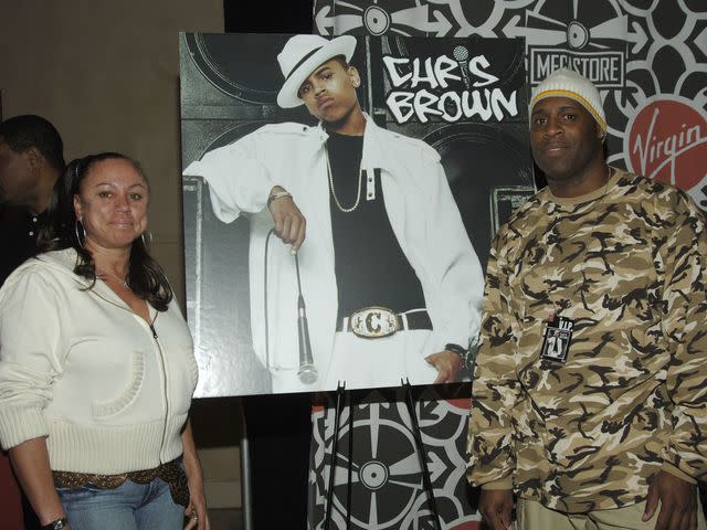 <p>L. Busacca/WireImage</p> Joyce Hawkins and Clinton Brown with poster of Chris Brown.