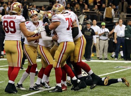 Nov 9, 2014; New Orleans, LA, USA; San Francisco 49ers kicker Phil Dawson (9) celebrates with teammates after kicking the game-winning field goal in overtime against the New Orleans Saints at Mercedes-Benz Superdome. The 49ers won 27-24. Mandatory Credit: Chuck Cook-USA TODAY Sports