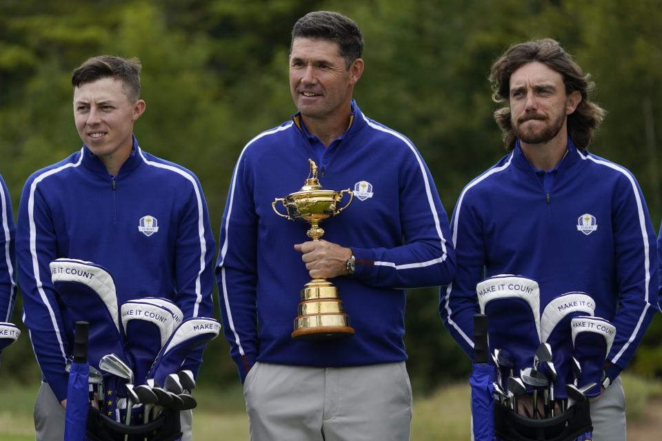 Team Europe captain Padraig Harrington is flanked by Team Europe's Matt Fitzpatrick and Team Europe's Tommy Fleetwood as they pose for a team picture at the Ryder Cup at the Whistling Straits Golf Course Tuesday, Sept. 21, 2021, in Sheboygan, Wis. (AP Photo/Charlie Neibergall)