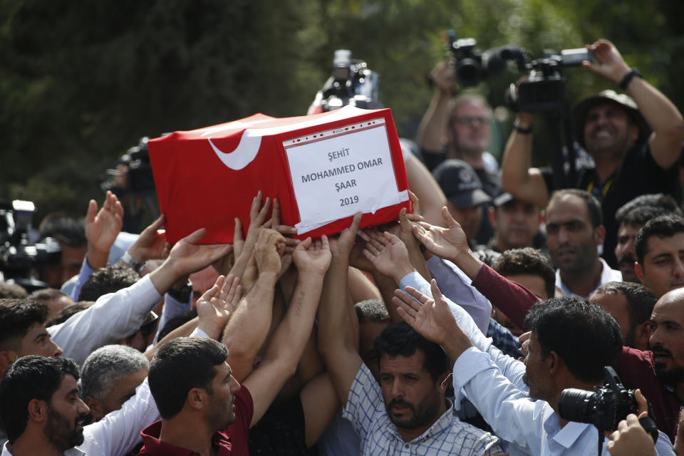 Mourners carry the coffin of ten-month-old Mohammed Omar Saar, killed during incoming shelling from Syria Thursday, in Akcakale, Sanliurfa province, southeastern Turkey, at the border with Syria, Friday, Oct. 11, 2019. (AP Photo/Lefteris Pitarakis)