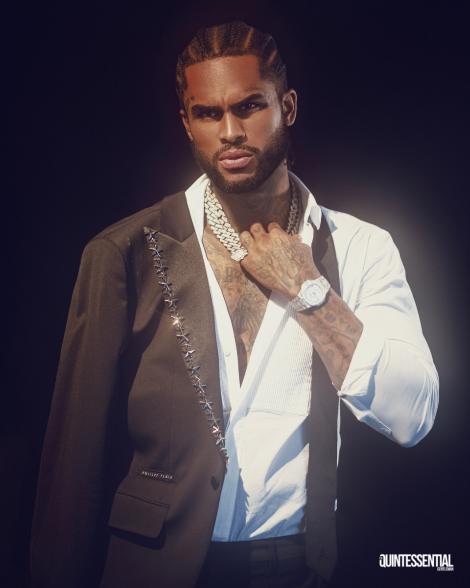 Dave East in The Quintessential Gentleman 2022 October style issue wearing black suit and whit dress shirt