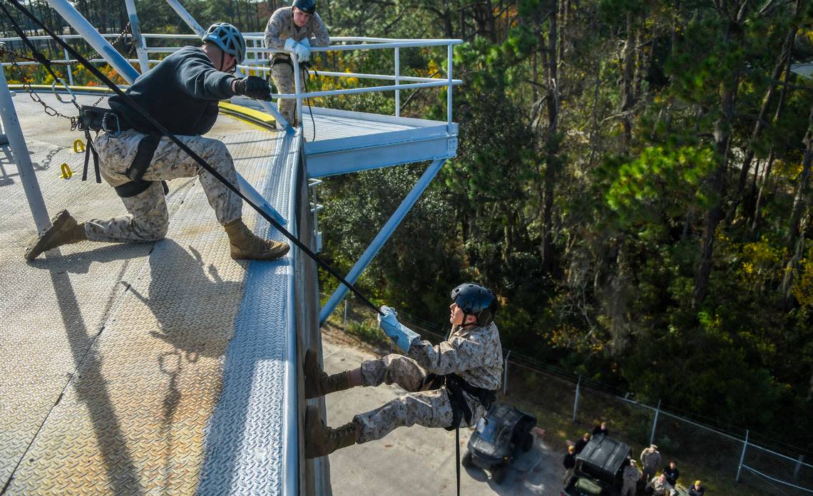 Sgt. Dylan Gillenkirk, left, instructs Trent Williams, 12, to shoot out his right arm as he rappels down the 48-foot wall on Thursday, Dec. 14, 2023, at Marine Recruit Depot Parris Island. Trent spent the day training as a Marine as part of the Make-A-Wish Foundation. Trent has hypoplastic left heart syndrome, a rare congenital birth defect that affects normal blood flow through his heart.