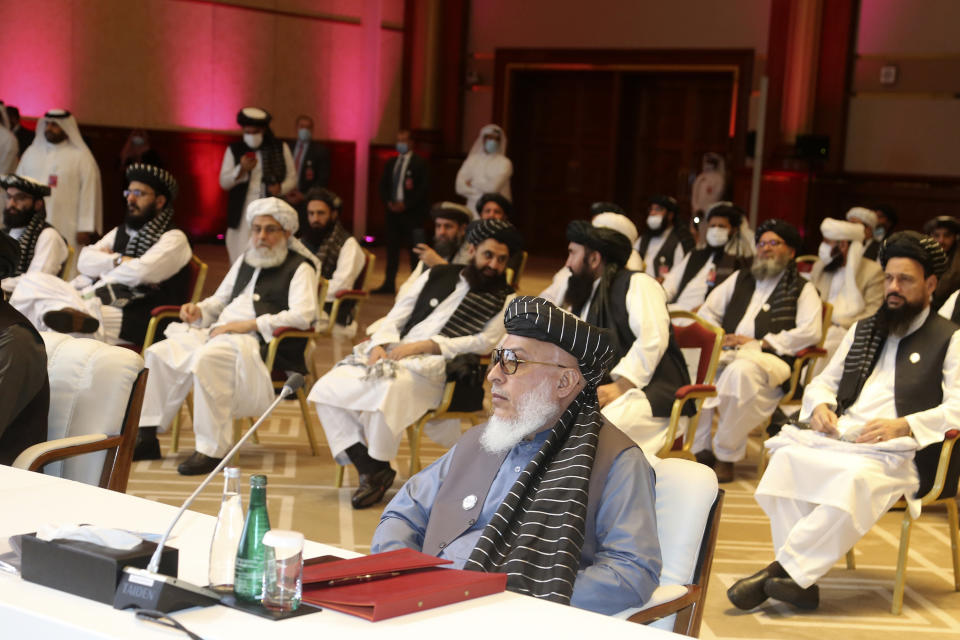 Taliban negotiator Abbas Stanikzai, right, with his delegation attends the opening session of the peace talks between the Afghan government and the Taliban in Doha, Qatar, Saturday, Sept. 12, 2020. (AP Photo/Hussein Sayed)